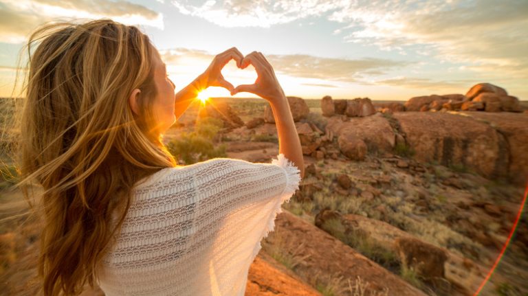 Girl making hand heart symbol