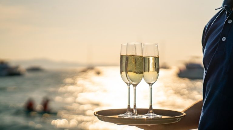 Man carrying champagne on a ship