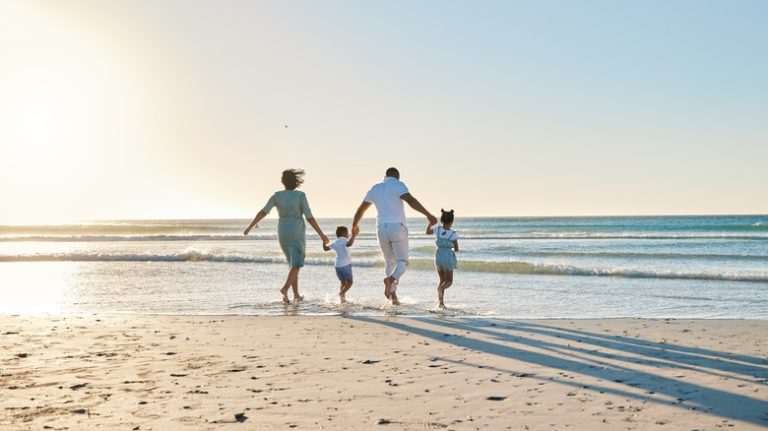 family walking along the beach