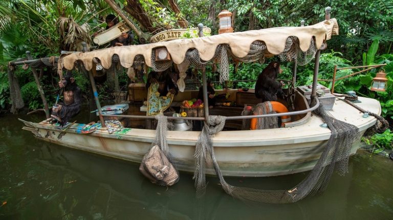 Two chimps on a boat on Disney's "Jungle Cruise" ride