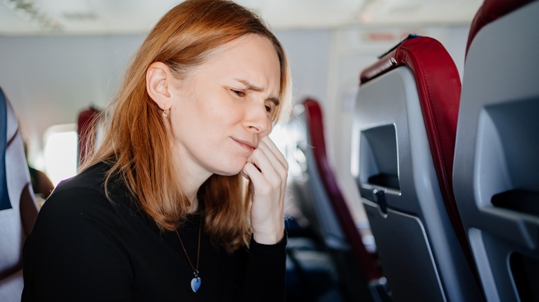 flight passenger with mouth pain