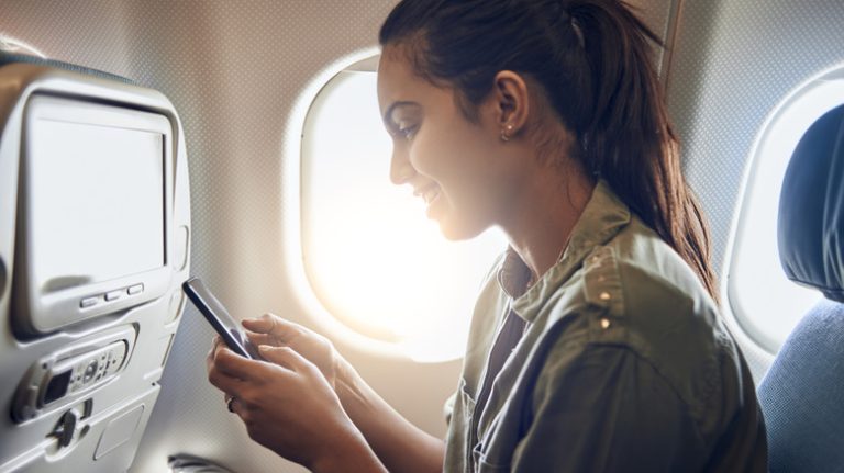 woman using phone on plane