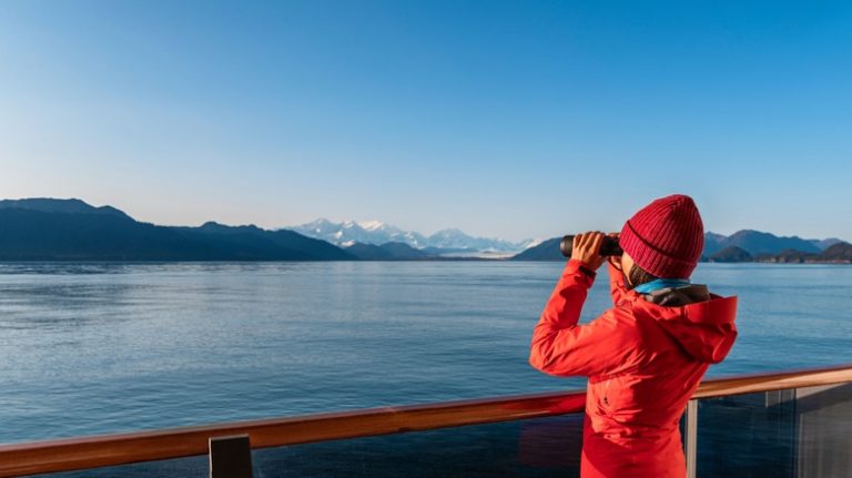 traveler with binoculars on a cruise