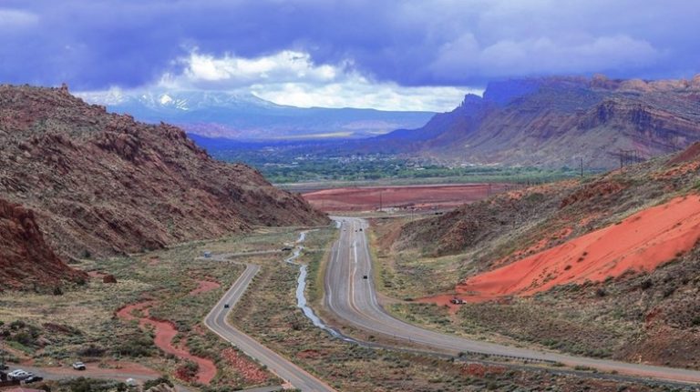 road snaking through colorful canyon