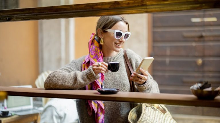 Woman drinking espresso at bar