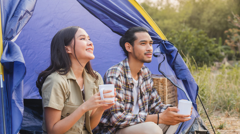 Happy couple in front tent