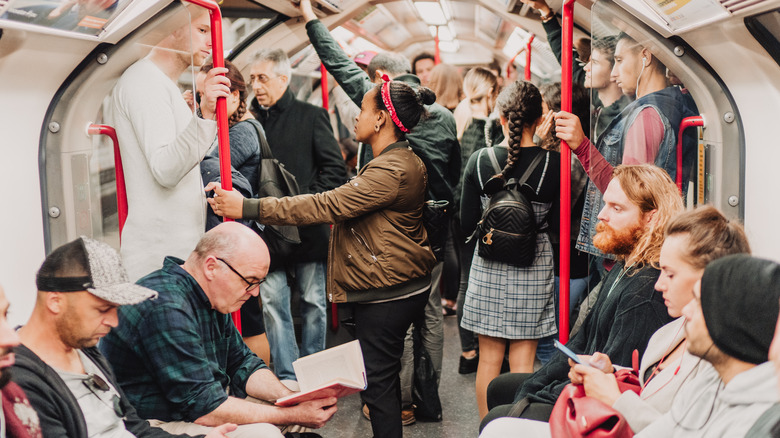 Travelers aboard one of London's underground trains