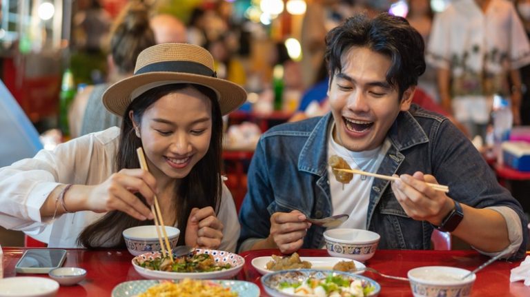 Couple eating street food together