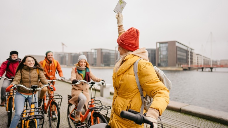 Tour guide leading group on bicycles