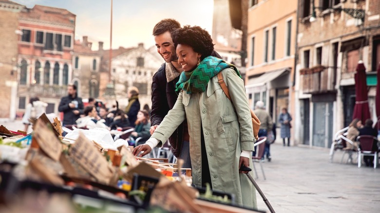 couple looking market stall street