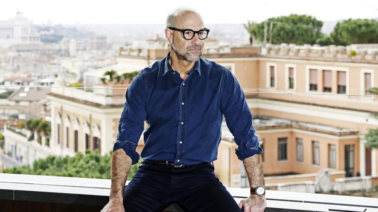 Stanley Tucci sitting on balcony