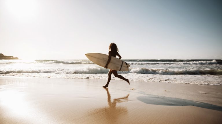 Surfer running at Bondi Beach