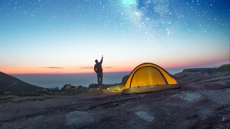 camping under the night sky