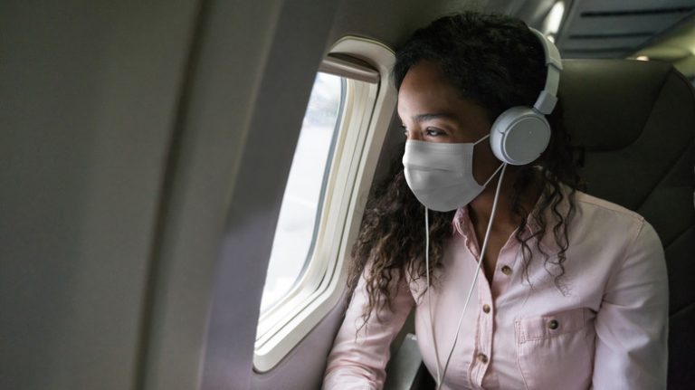 Woman wearing mask on plane