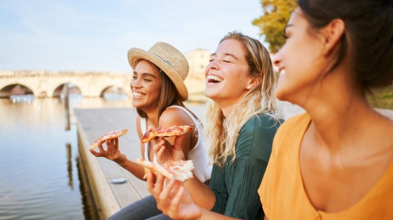 friends eating pizza in Rome