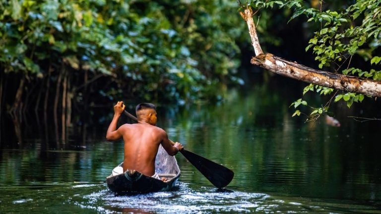 man canoeing the Amazon River