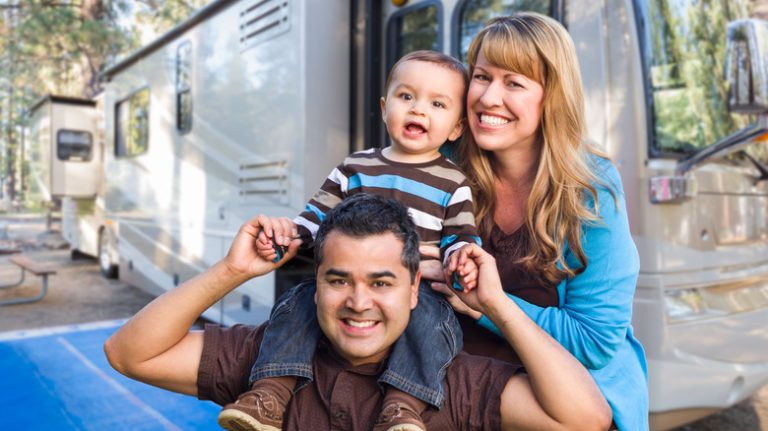 Laughing family with RV