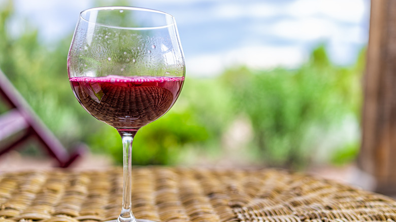 Red wine on wicker table