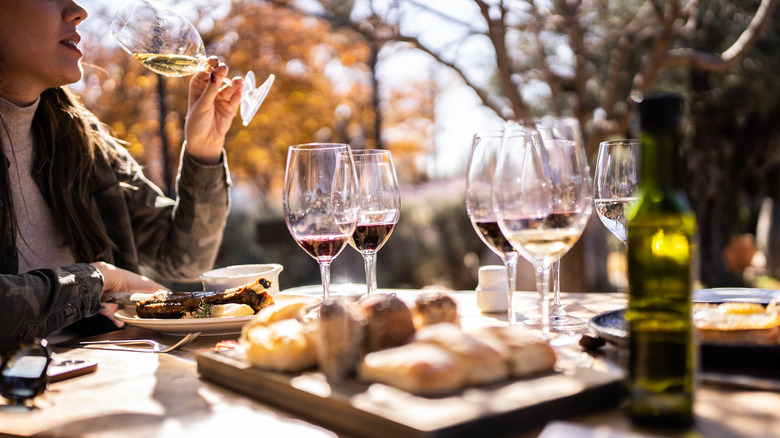 Woman sipping wine with meal