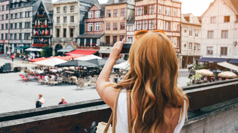 Woman taking pictures in Rouen, France