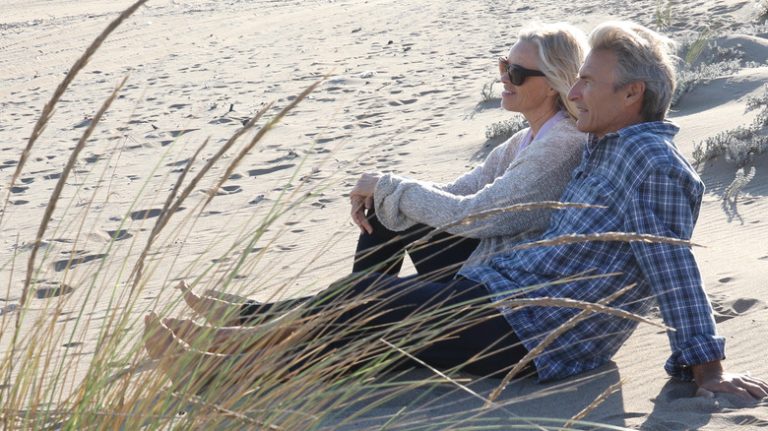 Couple sitting on the sand together