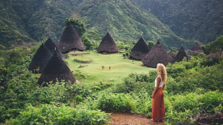 Traveler overlooking Wae Rebo village