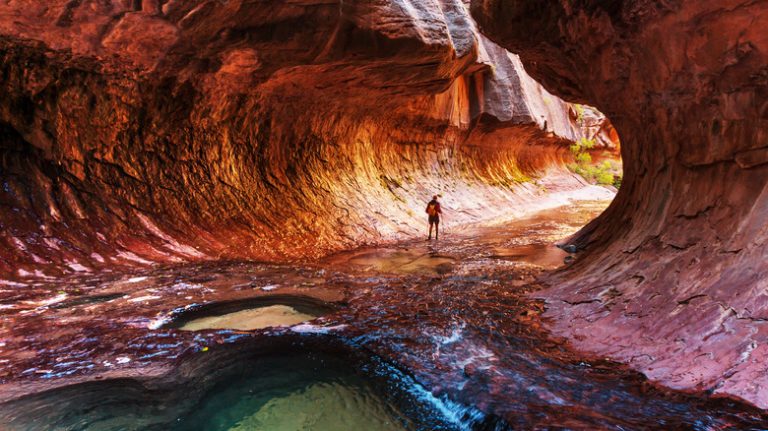 hiker in red slot canyon