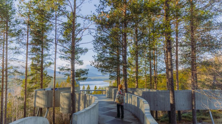 Woman walking on boardwalk in Norway