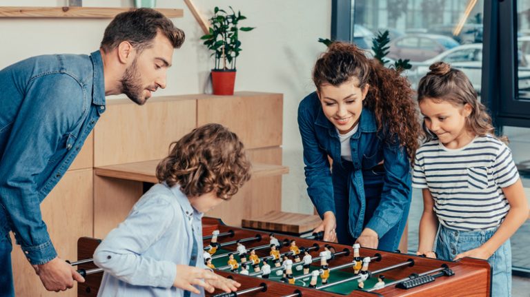 Family playing foosball