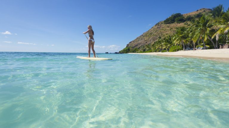 Woman paddleboarding in Fiji