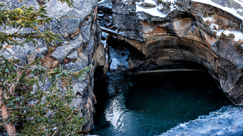 green water surrounded by rock