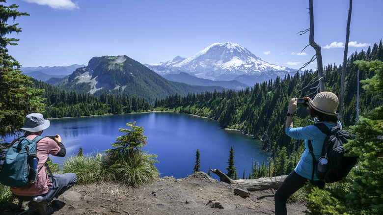 Hikers photographing Summit Lake