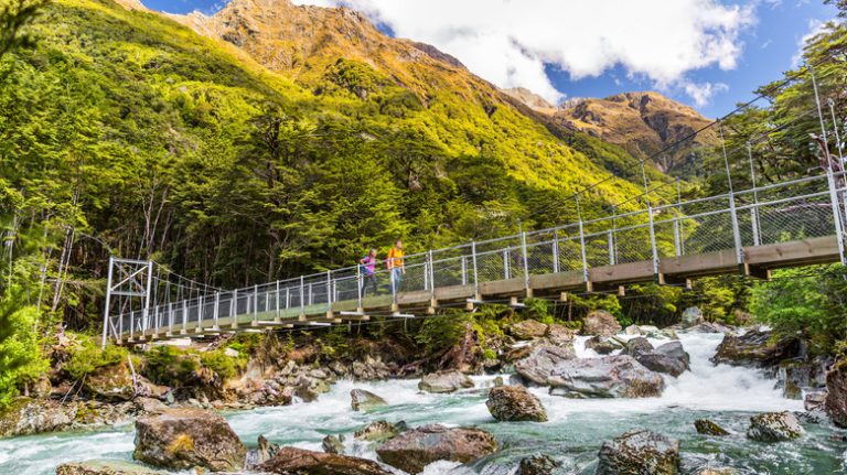 hikers on swing bridge