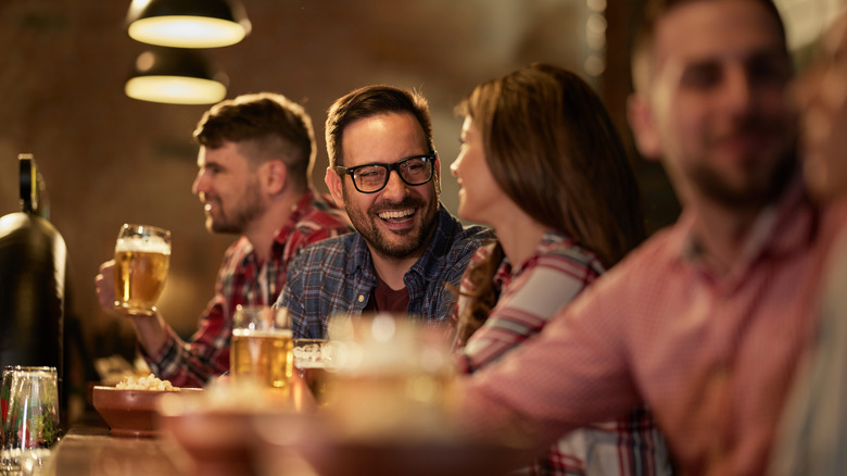 People drinking beer inside a pub