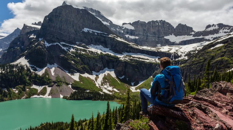 Man observing lake at Glacier National Park