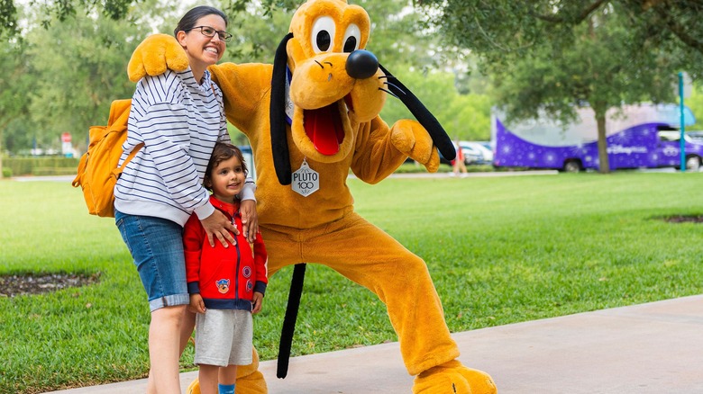 Family taking photo with Pluto