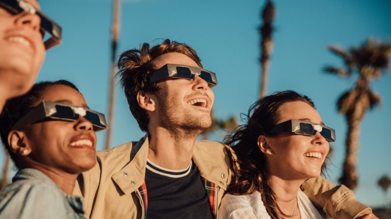 friends watching solar eclipse