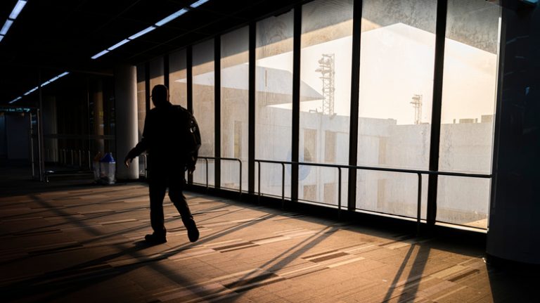 Man walking through an airport terminal