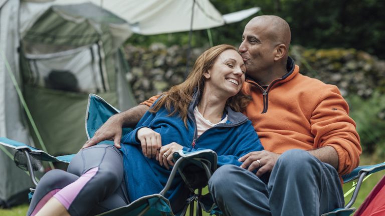 couple relaxingin camping chairs