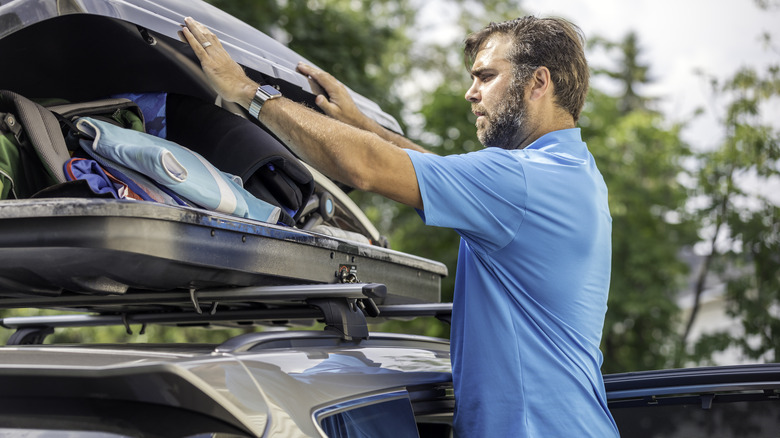 Man packing rooftop carrier