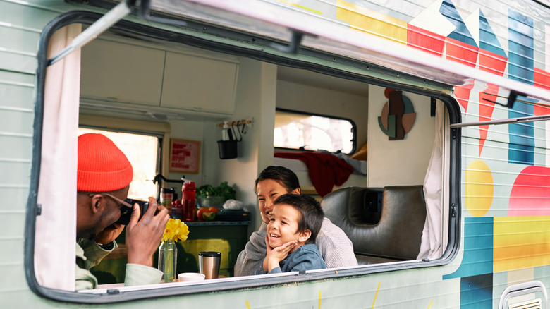 Happy family in their RV window