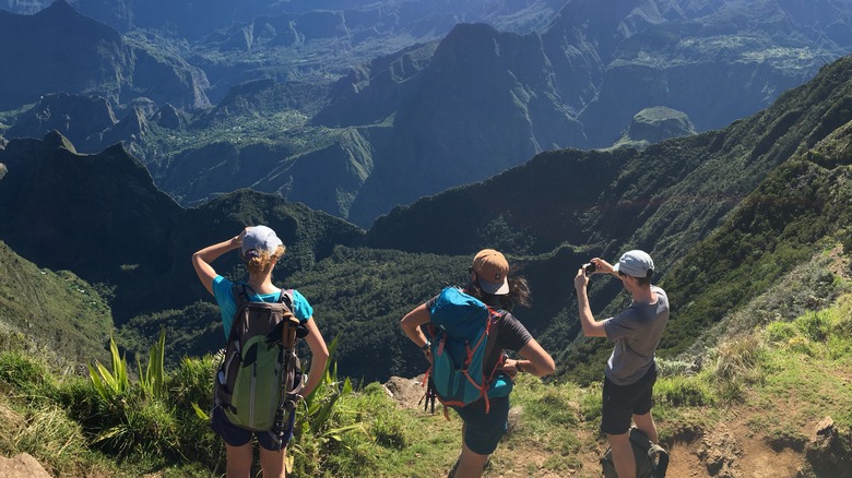 Three hikers gazing over a valley