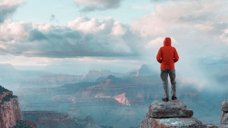 hiker looking over Grand Canyon