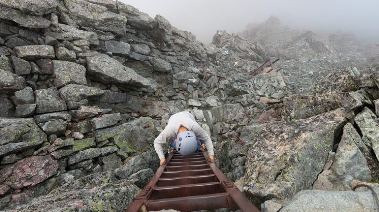 Hiker climbing Daikiretto ladder