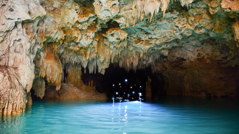 Headlamps visible in a cave