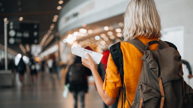 Woman walking towards airport gate