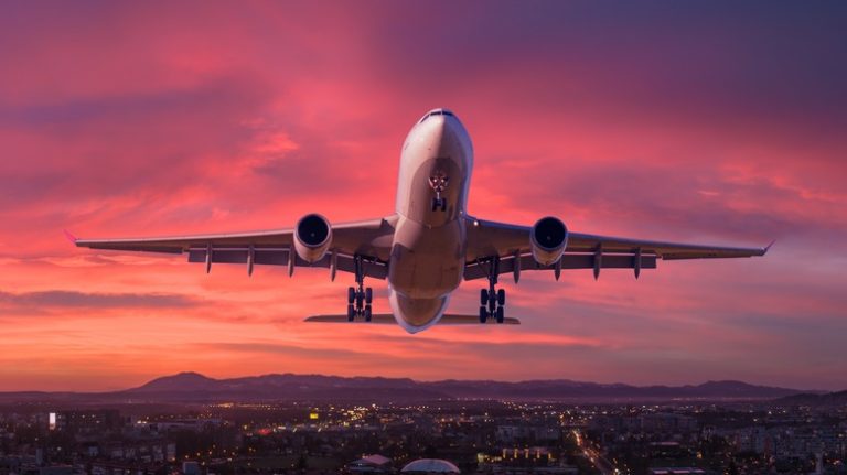 plane taking off at sunset