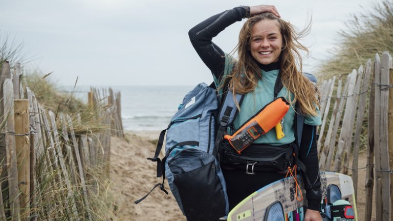 Woman carrying things on beach