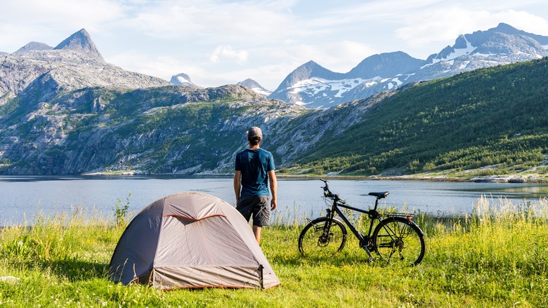 man looking at mountain range