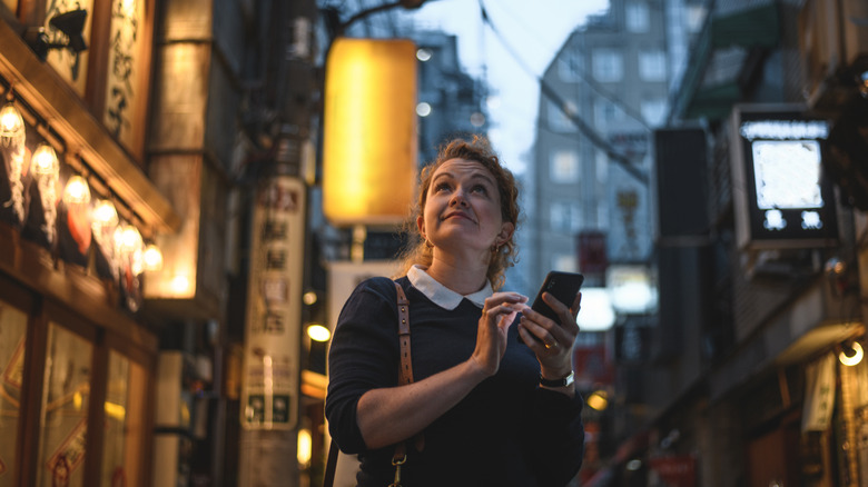 woman with phone in hand